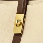 Gold-tone turn-lock detail on canvas tote